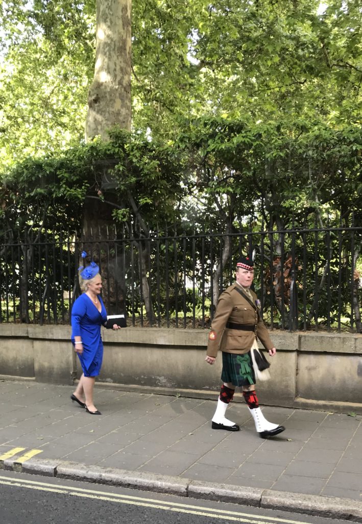 Dressed up couple in London coming from Palace Garden Party One Day