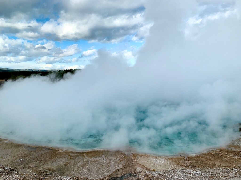 Aqua colored geyser above waterfall Grand Prismatic Spring Yellowstone