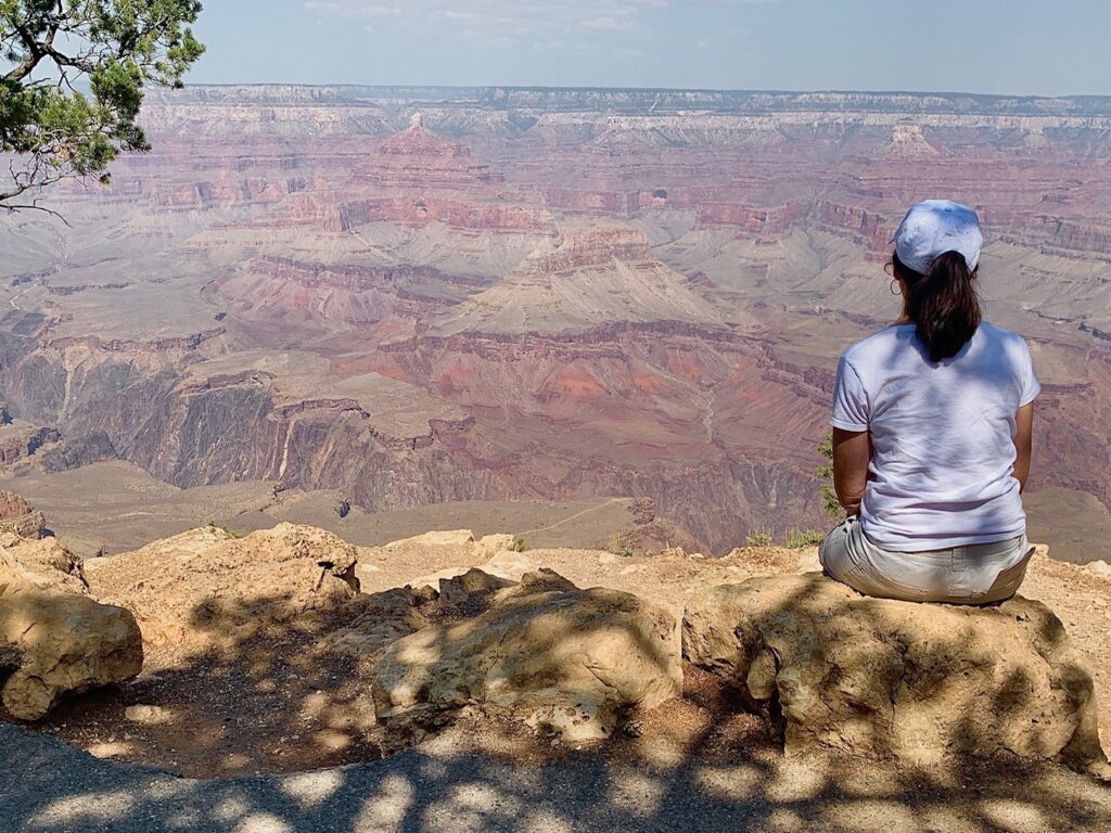 Sitting on rocks taking in Grand Canyon