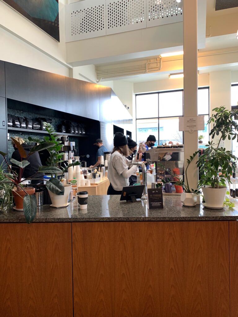 Baristas cranking out orders at Messenger Coffee Co KC