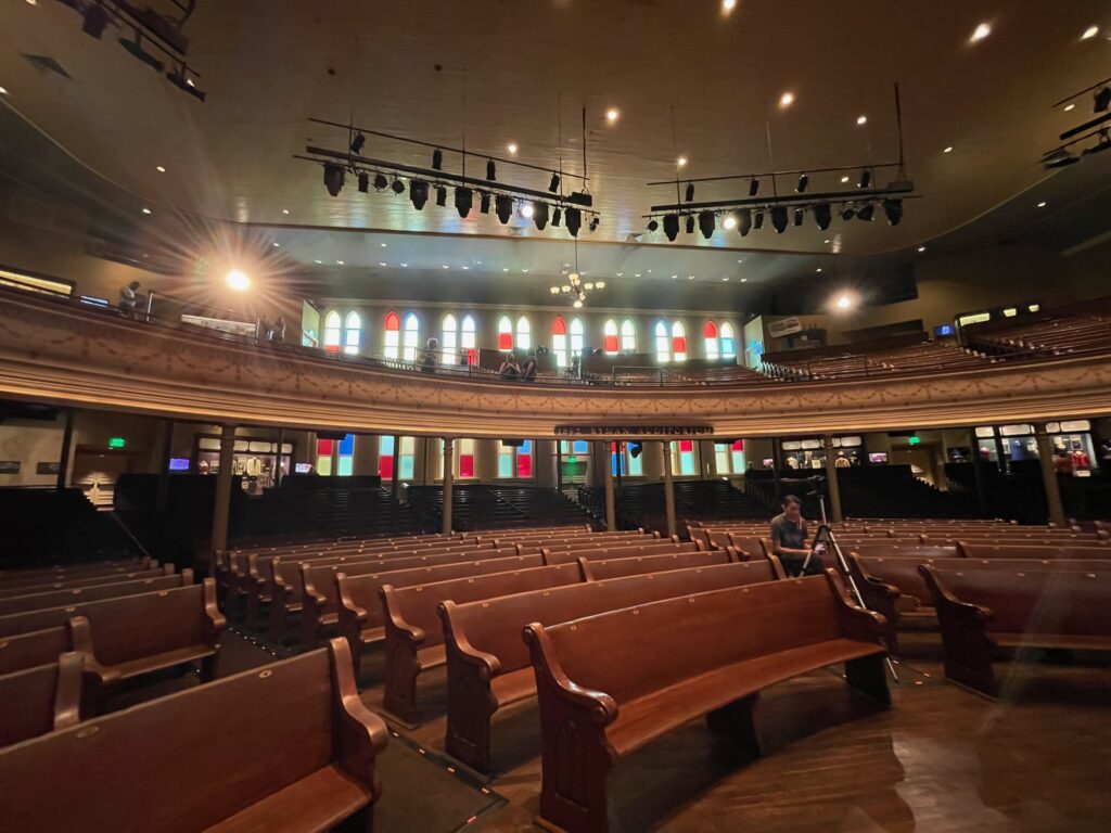 Ryman Auditorium inside with stained glass windows and pews