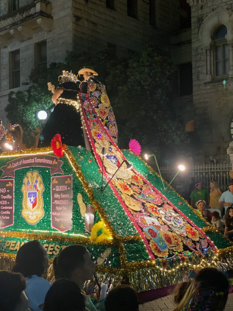 One Queen's dress train on Float at Fiesta's Flambeau Parade