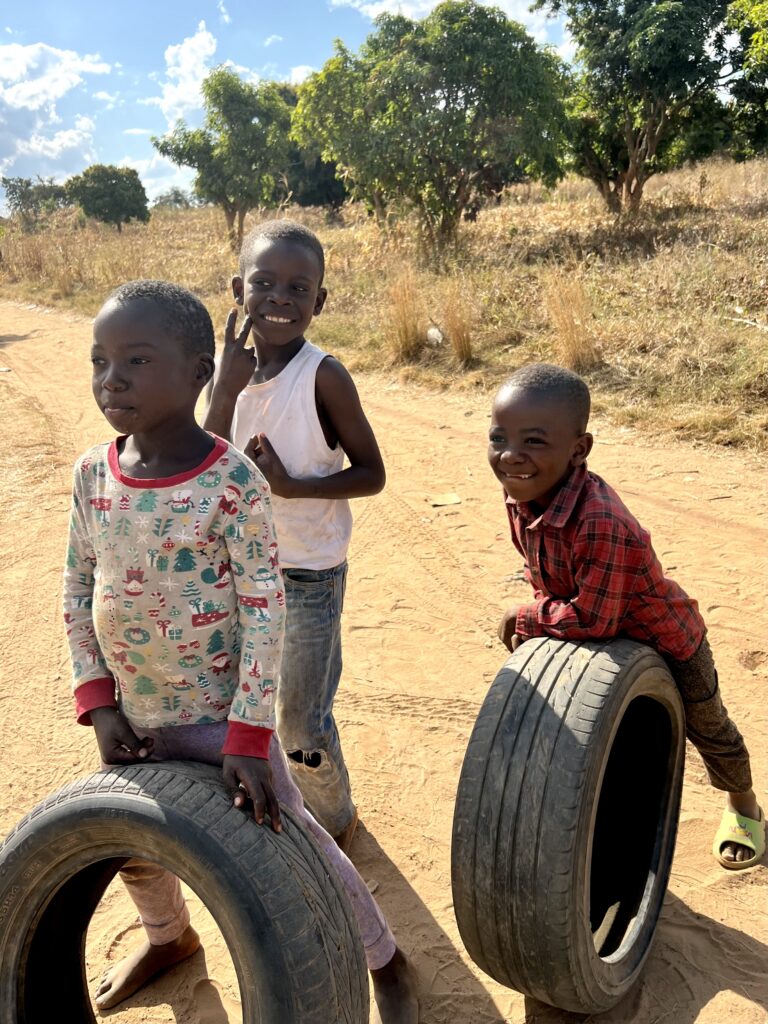 Children playing with tires in the village.